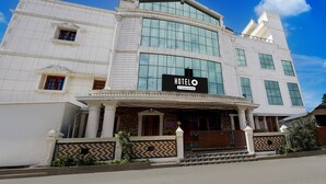 A hotel with a prominent 'HOTEL' sign, large windows, and a classic architectural design. - Deluxe kk Residency (Karaikal)