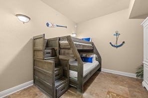 A bunk bed with storage drawers, a wall-mounted light fixture, and an anchor decoration. - Spacious Coastal Retreat | Complimentary Beach Service (Destin)