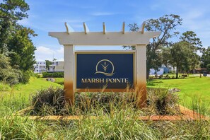 A sign for 'MARSH POINTE' with a logo, surrounded by greenery and a clear sky. - Choose Happiness Updated 4 BR short golf cart ride Pawleys Pet Friendly (Pawleys Island)
