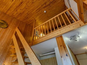 A wooden interior with a staircase leading to a loft area. - Renovated alpine apartment, mountain view - 10 guests (Plagne Villages)