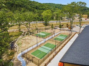A tennis court complex with multiple courts, a walking path, and a natural landscape with trees and hills in the background. - Pond View Hot Tub 4 Ensuite Bedrooms Lazy River (Hollister)