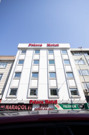 A building with the sign 'Pelora Hotel' at the top.