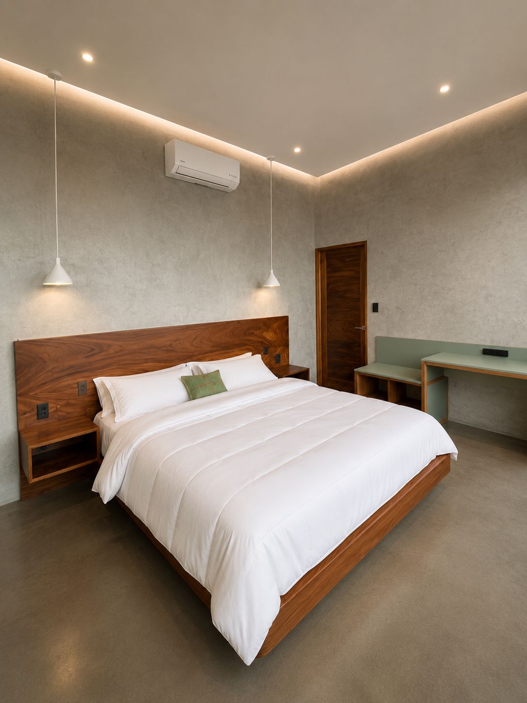 A modern bedroom with a wooden headboard, a bed with white bedding, two pendant lights, a desk, and an air conditioning unit.
