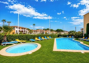 A resort pool area with multiple lounge chairs and a large swimming pool. - Cosy and quiet place/ apartement with beautiful vue  and sunset on port grimaud! (Cogolin)