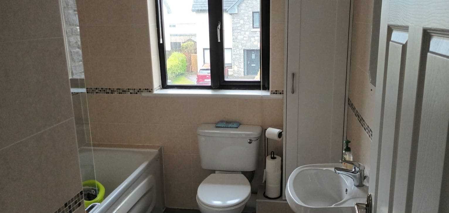 A compact bathroom with a toilet, sink, and bathtub.