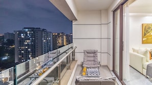A balcony with a chessboard, a cushioned chair, and a sofa. - Luxury 4BR All-ensuite Heated Pool Riverside, Nairobi (Nairobi)