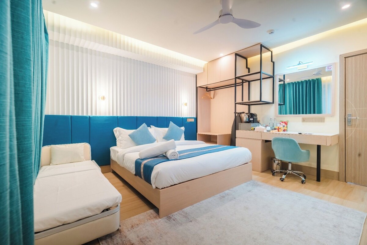 Deluxe Quadruple Room | In-room safe, desk, laptop workspace, blackout drapes