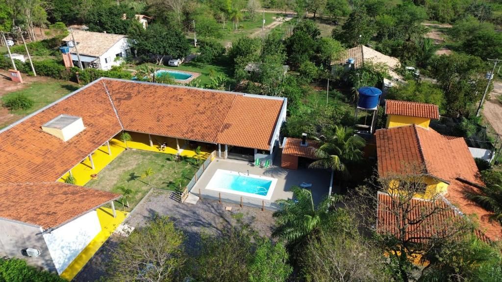 A residential property with a swimming pool, a covered patio, and a fenced yard.