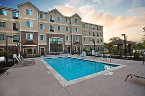 A hotel with a swimming pool, lounge chairs, and a covered seating area. - Accessible 2BR Suite | Free Daily Breakfast & Pool (Austin)