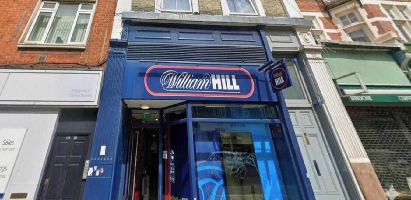 A storefront with a prominent sign reading 'William Hill.'