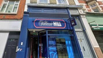A storefront with a prominent sign reading 'William Hill.'