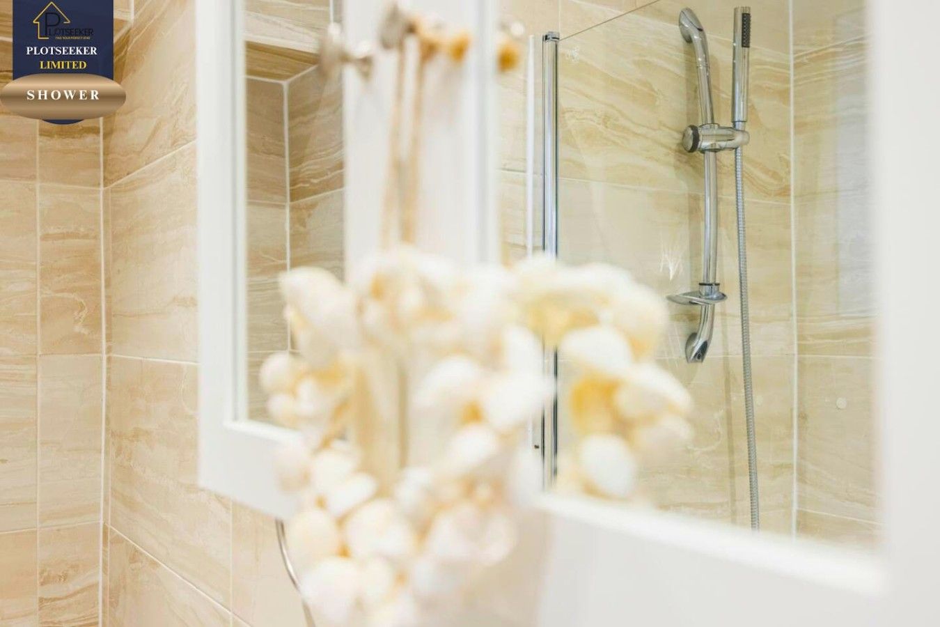 A shower with a glass door and a showerhead.
