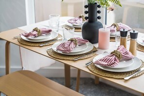 A dining table set with plates, cutlery, and napkins tied with a rope. - Coastal retreat near Morecambe Bay and promenade (Heysham)