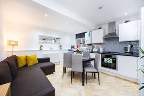 Eine moderne Wohnung mit Wohnzimmer, Essbereich und Küche.