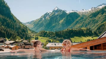 A swimming pool with a mountainous landscape in the background.