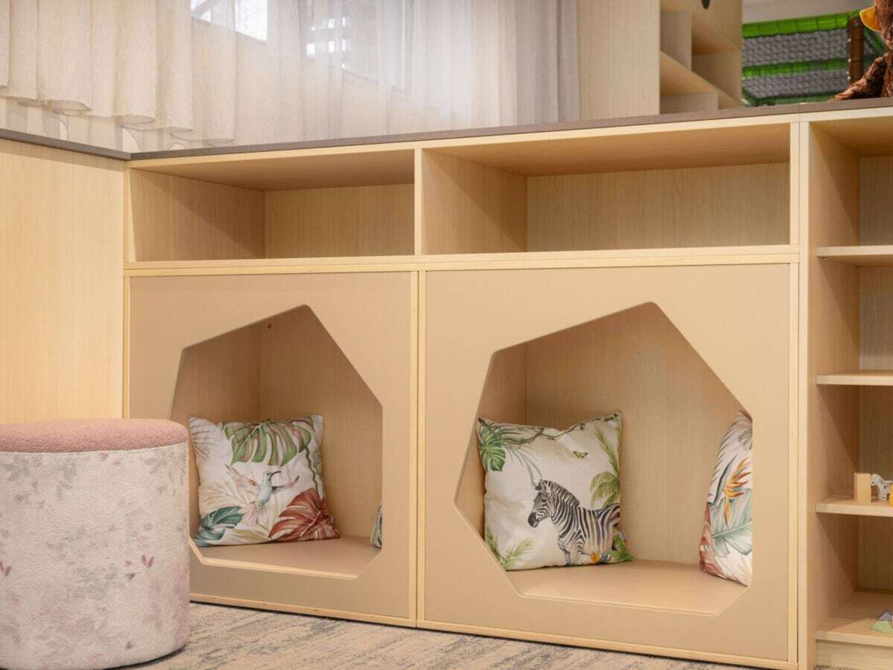 A children's play area with built-in seating and storage shelves.