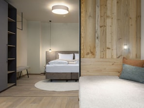 Quarto moderno com cama, mesa de cabeceira e cabeceira de madeira.