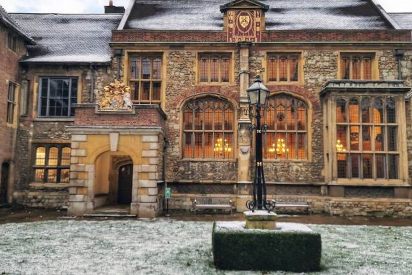 A historic building with a stone facade, arched windows, and a prominent clock tower.