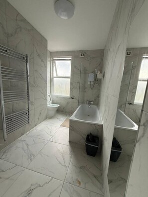A bathroom with a bathtub, toilet, and a shower area. - Private Room | Own Kitchen & Bathroom | Near Tube (Greater London)