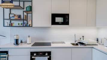 A modern kitchen with a Bosch microwave, a built-in oven, and a sink.