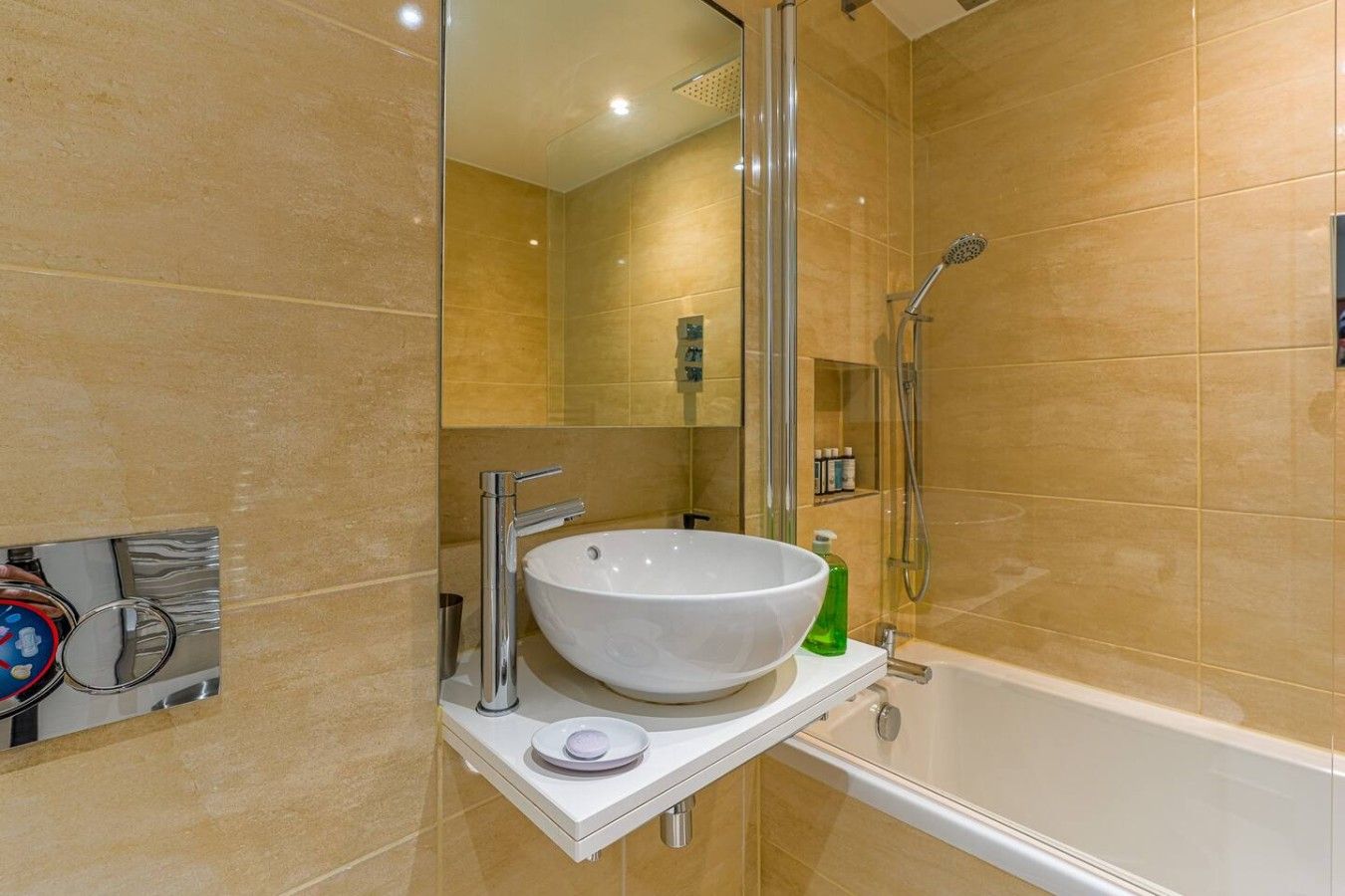 A bathroom with a white sink, a glass shower enclosure, and a bathtub.