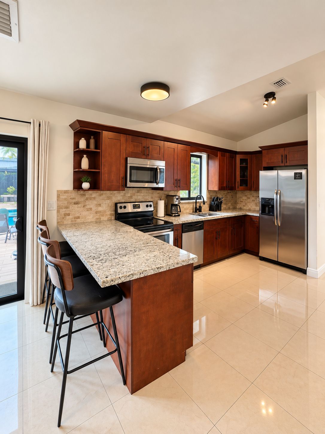 A modern kitchen with a granite countertop, stainless steel appliances, and wooden cabinets.