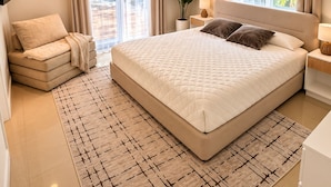 A modern bedroom with a large bed, a sofa, and a potted plant. - •4BR·3BA Miami Oasis, Big Yard, Pool & Jacuzzi, Perfect for Vacations & Events• (Miami)