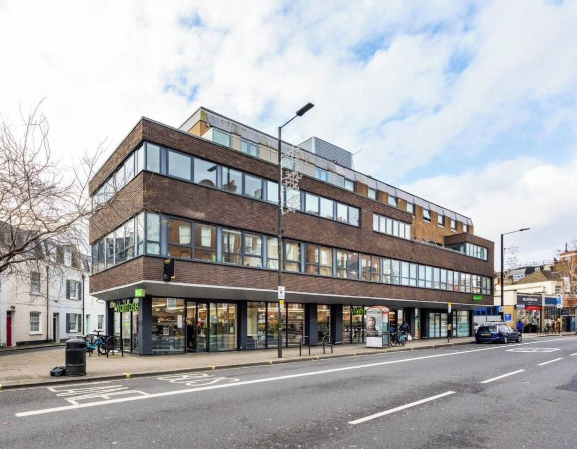A modern building with a ground floor retail space and upper residential or office units.