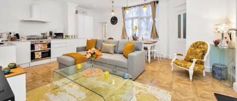 A modern living space with a kitchen, dining area, and seating.