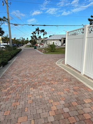 A paved pathway leading to a gated area with a building labeled '295' in the background. - Cozy 1-bedroom apartment in fabulous Bonita Shores, Bonita Springs 1 mi to beach (Bonita Springs)