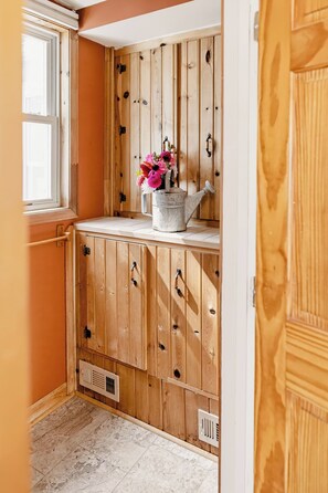 A wooden cabinet with multiple drawers and a window above it. - Bloom + Shore: Charming Lakefront Cottage on Conesus Lake (Geneseo)