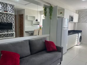 A modern kitchen with a built-in oven, microwave, and a washing machine. - 303 2-bedroom apartment 15 min center (Belém)