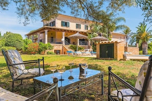 A villa with a pool, outdoor seating, and a covered patio area. - Holiday Home 'Can Bou' with Sea View, Wi-Fi and Air Conditioning (Ses Salines)
