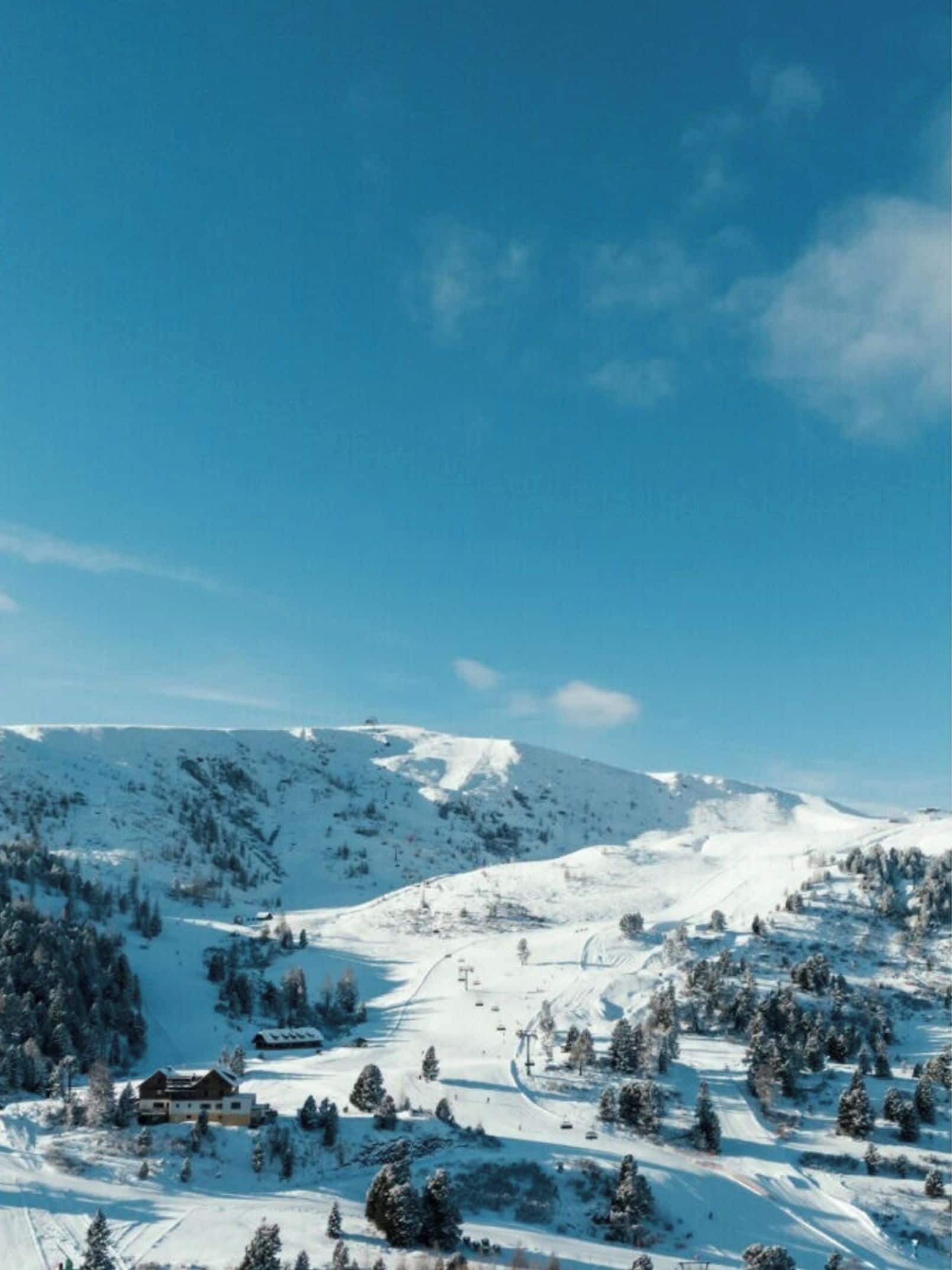 A snow-covered mountain landscape with a clear sky.