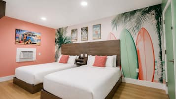 Een hotelkamer met twee bedden, een muurschildering in strandthema en een decoratie van een surfplank.