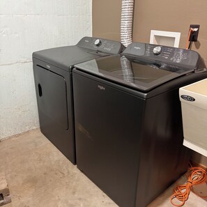 A compact washer and dryer unit with a control panel, located in a room with a tiled wall and a visible electrical outlet. - Mohawksin Magic! Lakeside 2 Bdrm Lower-Level Home & Garage - 3 Miles to Tomahawk (Tomahawk)
