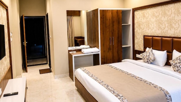 A hotel room with a bed, a wardrobe, a desk, and a television. - The Lalan Palace (Udaipur)