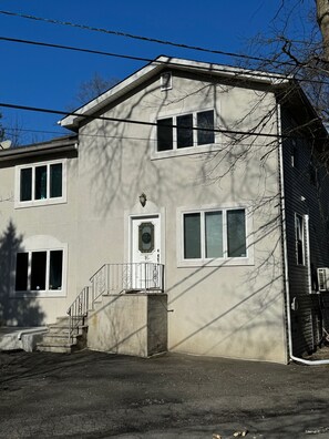 A two-story building with a front entrance, a small porch, and a visible number '16'. - Cozy 1-bedroom apartment in perfect Hillsdale with AC (Hillsdale)