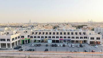 A multi-story building with a parking lot in front.
