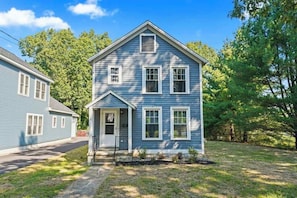 A two-story house with a front porch and a small garden. - Walk to Saratoga Track | 2 Kings | Pet OK (Saratoga Springs)