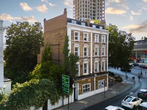 Un edificio a più piani con uno stile architettonico classico, caratterizzato da una facciata in mattoni e numerose finestre.