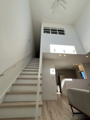 A staircase leading to an upper level with a ceiling fan, recessed lighting, and a view of the sky through a window. - R's House | Newly Built Entire House | Within Walking Distance of Sumikawa Station | Adjacent to the Host's Home · Two-Generation House | Parking for 2 Cars | Accommodates up to 6 Guests (札幌市南区澄川5条5丁目)