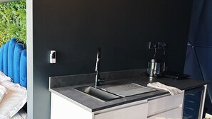 A modern kitchen with a built-in sink, a coffee machine, and a microwave. - Luxury Igloo Dome with Hot Tub (Redberth)