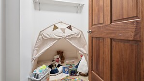 A child's play area with a tent, toys, and books. - The Vita and Vine: Lakefront, Outdoor Theater (Rushville)