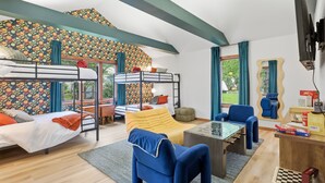 A room with bunk beds, a sofa, a coffee table, and a desk. - The Vita and Vine: Lakefront, Outdoor Theater (Rushville)