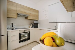 A modern kitchen with a built-in oven, a microwave, and a sink. - Luxury Sea-View Villa with Private Pool & Coastal Charm in Larnaca. Book now! (Sophtadhes)