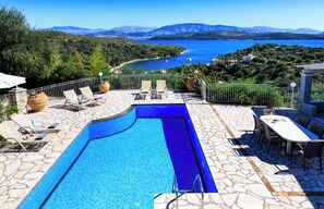 A swimming pool with a view of a lake and mountains. - Evangelia, a tranquil Corfu retreat with panoramic sea views and easy village access (Kassiopi)