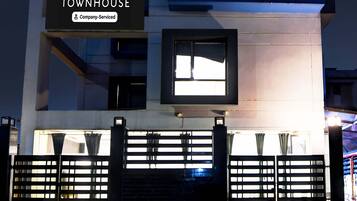 A building with a sign reading "TOWNHOUSE Company-Serviced."
