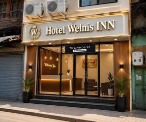 Hotel Welnis Inn with a 'Townhouse' sign, a reception desk, and a 'Welcome You' sign. - Deluxe Room Hotel Welnis Inn (Amritsar)