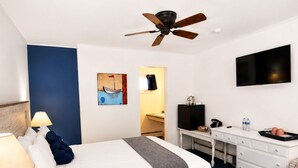 A hotel room with a bed, desk, chair, TV, and a ceiling fan. - Towne Motel Camben Room #7 (Camden)